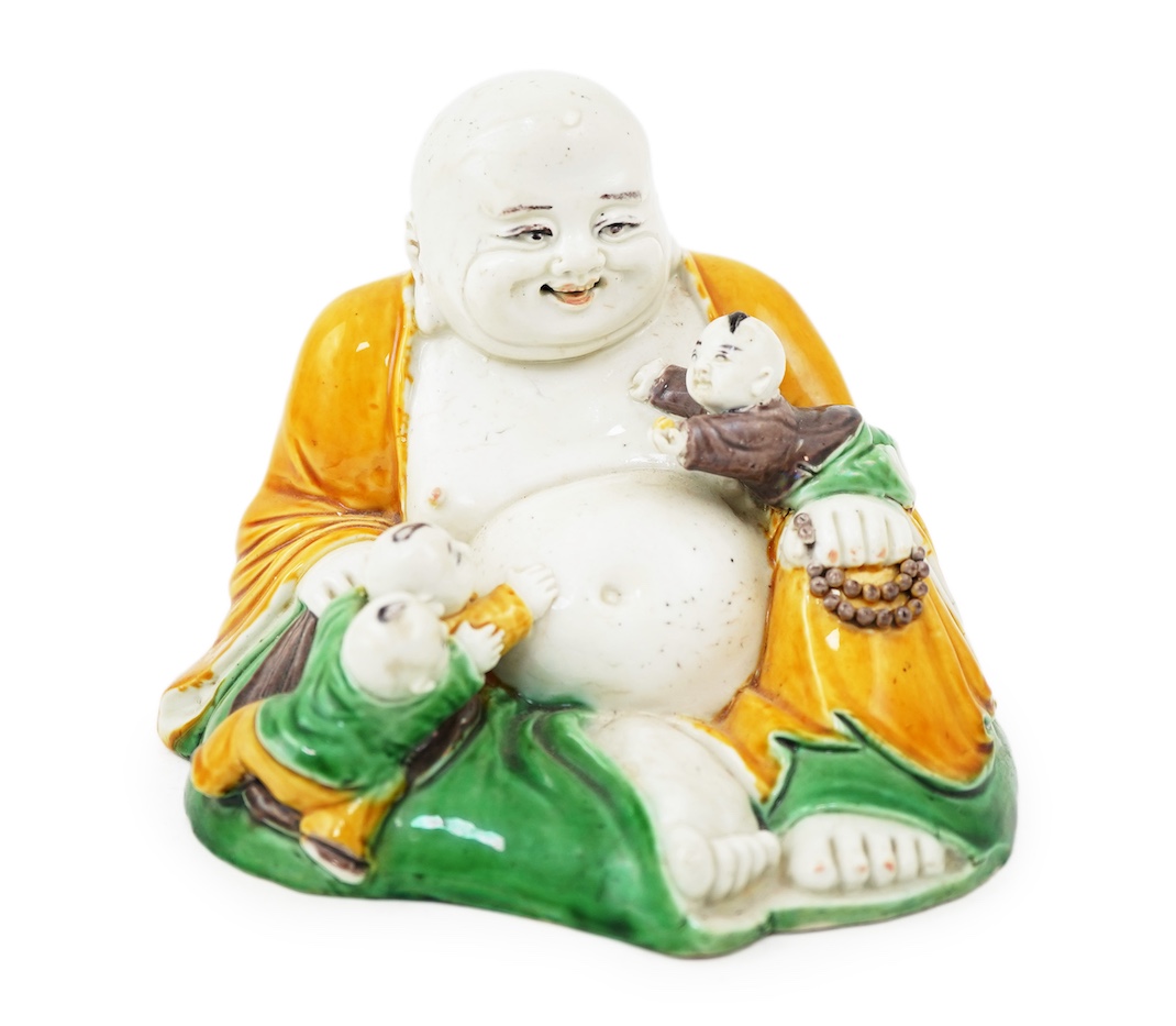 A Chinese sancai glazed biscuit group of Budai and three boys, 19th century